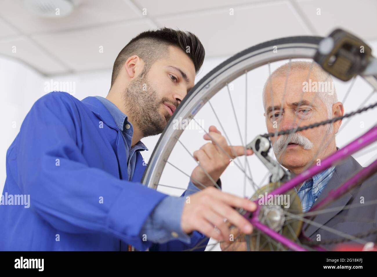 the mechanics working on bicycle Stock Photo Alamy