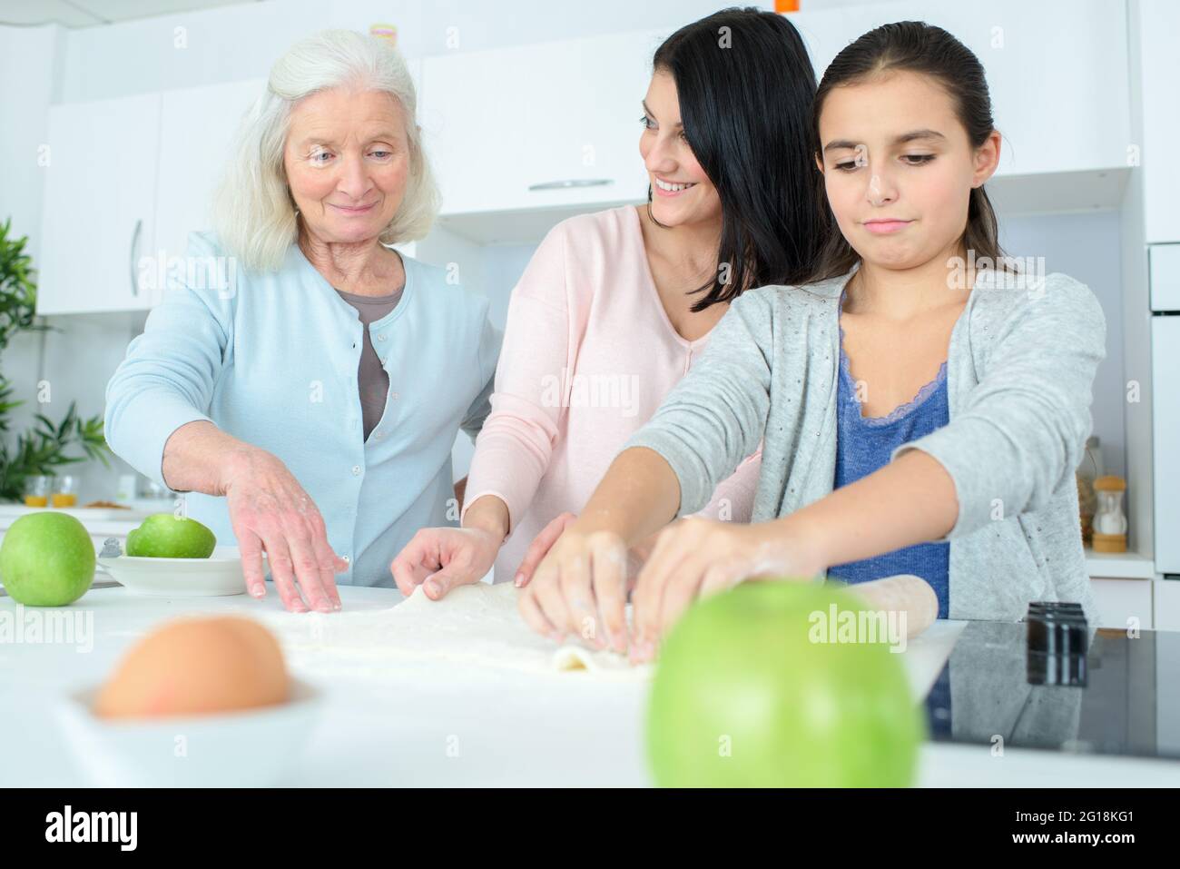 three generations of women baking together Stock Photo - Alamy