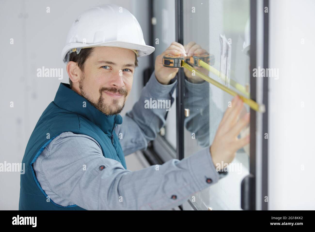 happy man measuring a window Stock Photo - Alamy