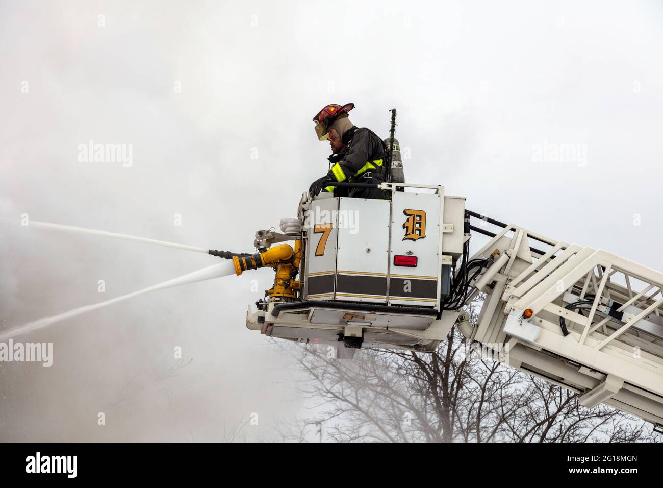 Firefighters in Tower Ladder fighting fire, Detroit, Michigan, USA, by James D Coppinger/Dembinsky Photo Assoc Stock Photo