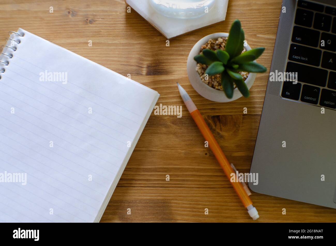 Overhead shot of desk with notepad, laptop, pencil Stock Photo - Alamy