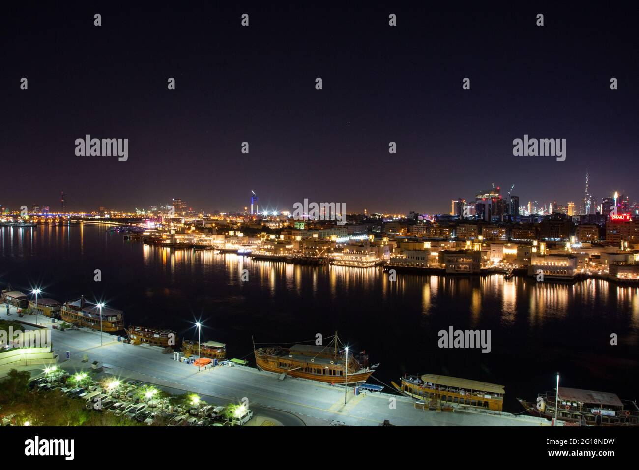 Night view of the gold souk and the creek with Burj Khalifa towering in the distance. Dubai, UAE, 12.12.2018 Stock Photo