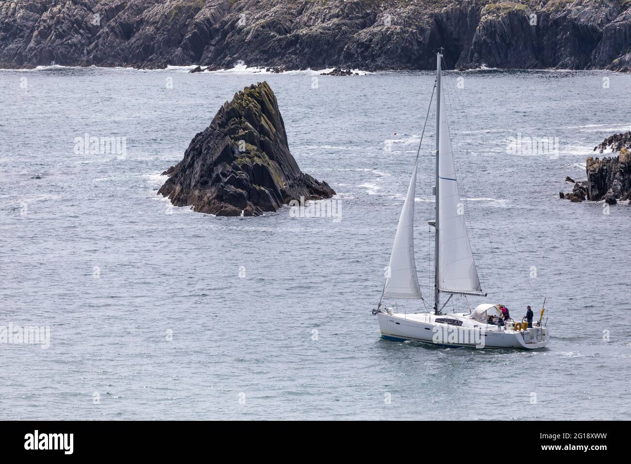 Baltimore, Cork, Ireland. 05th June, 2021. The yacht Inisleigh sails out under full canvas aroud the jagged coastline outside Baltimore Harbour in West Cork, Ireland. -Credit; David Creedon / Alamy Live News Stock Photo