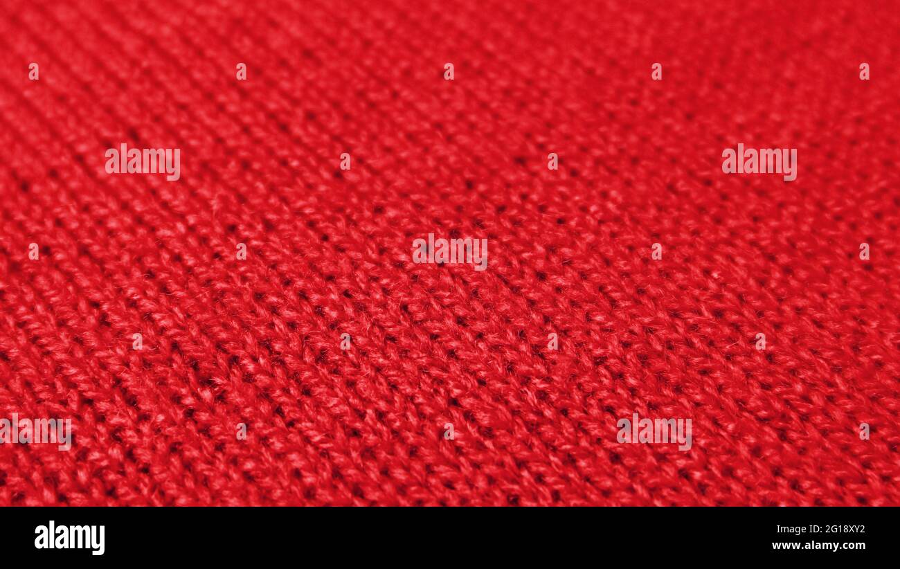 Red Knitted Wool Fabric in Diagonal Patterns with Selective Focus Stock Photo