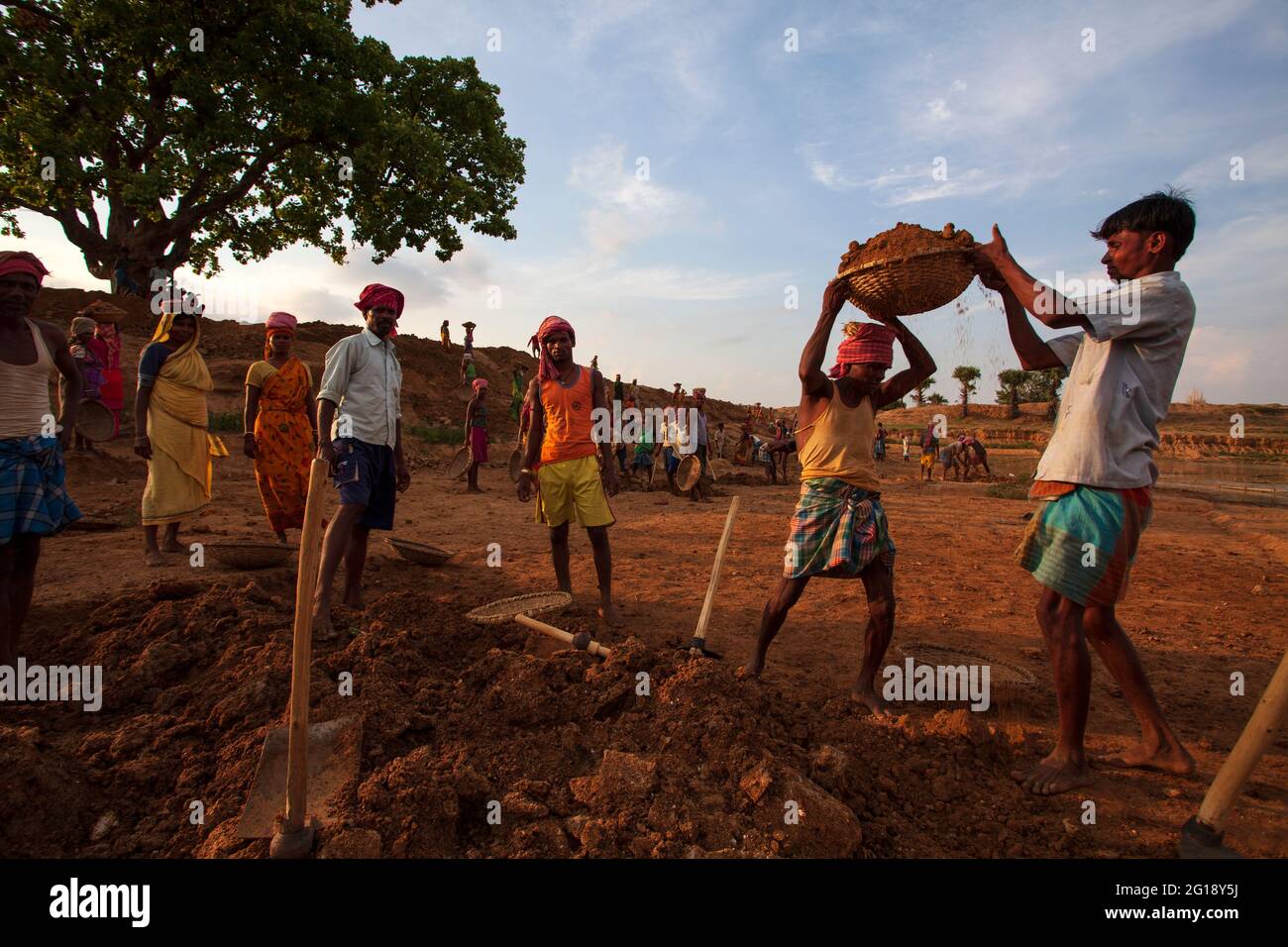 Daily labours are working to dig a pond and carrying soil Stock Photo