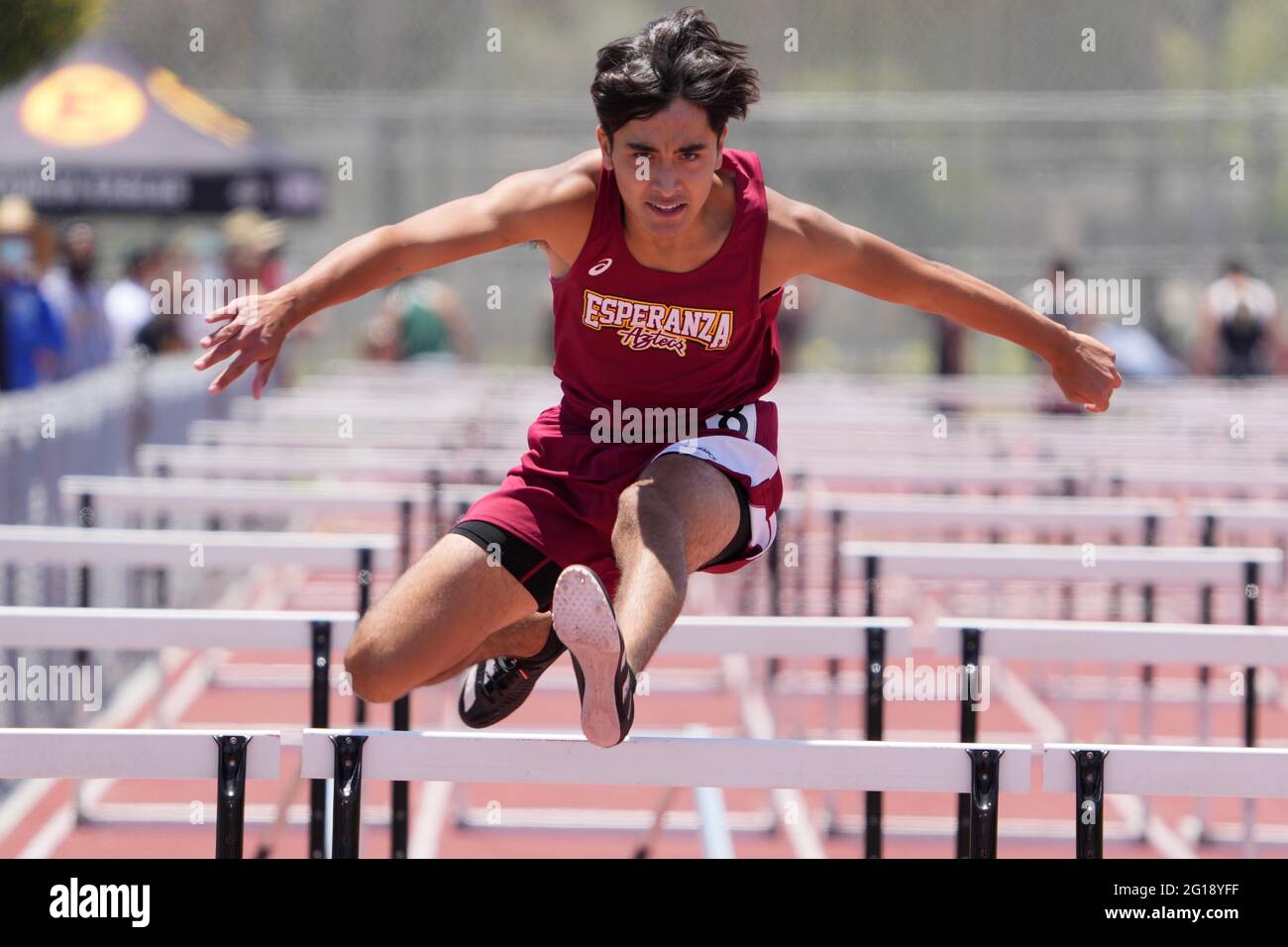 Jonathan Regalado of Esperanza runs in a 110m hurdles heat during the