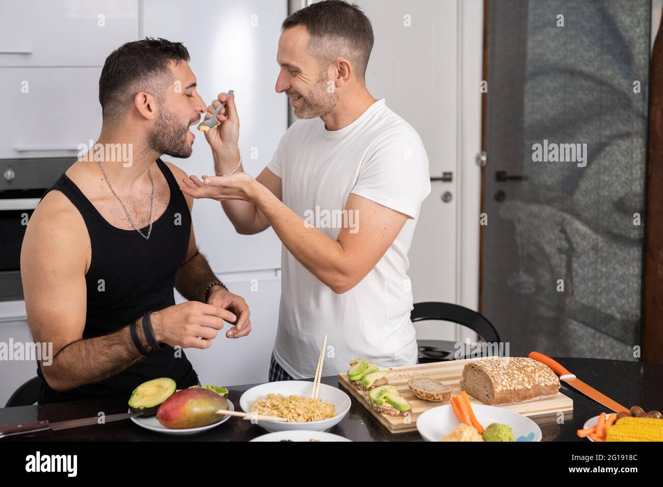Gay couple cooking healthy vegan food together at home Stock Photo Alamy