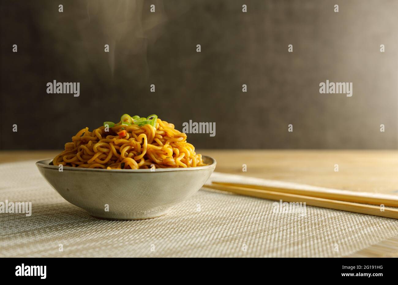 Japanese food , vegetable noodles in Teriyaki sauce served in a bowl with chopsticks on the side. Stock Photo