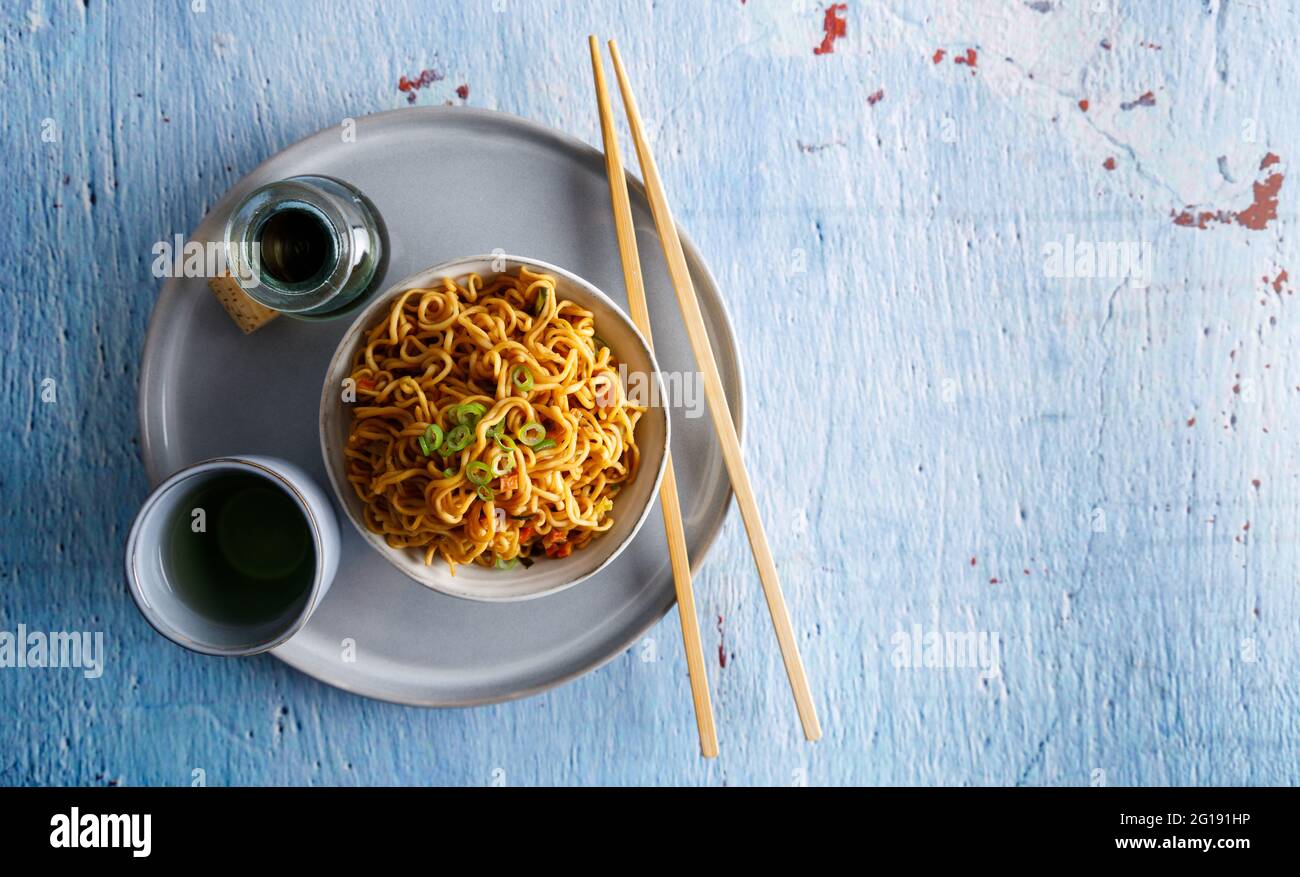 Japanese food , vegetable noodles in Teriyaki sauce served in a bowl with chopsticks on the side. Stock Photo