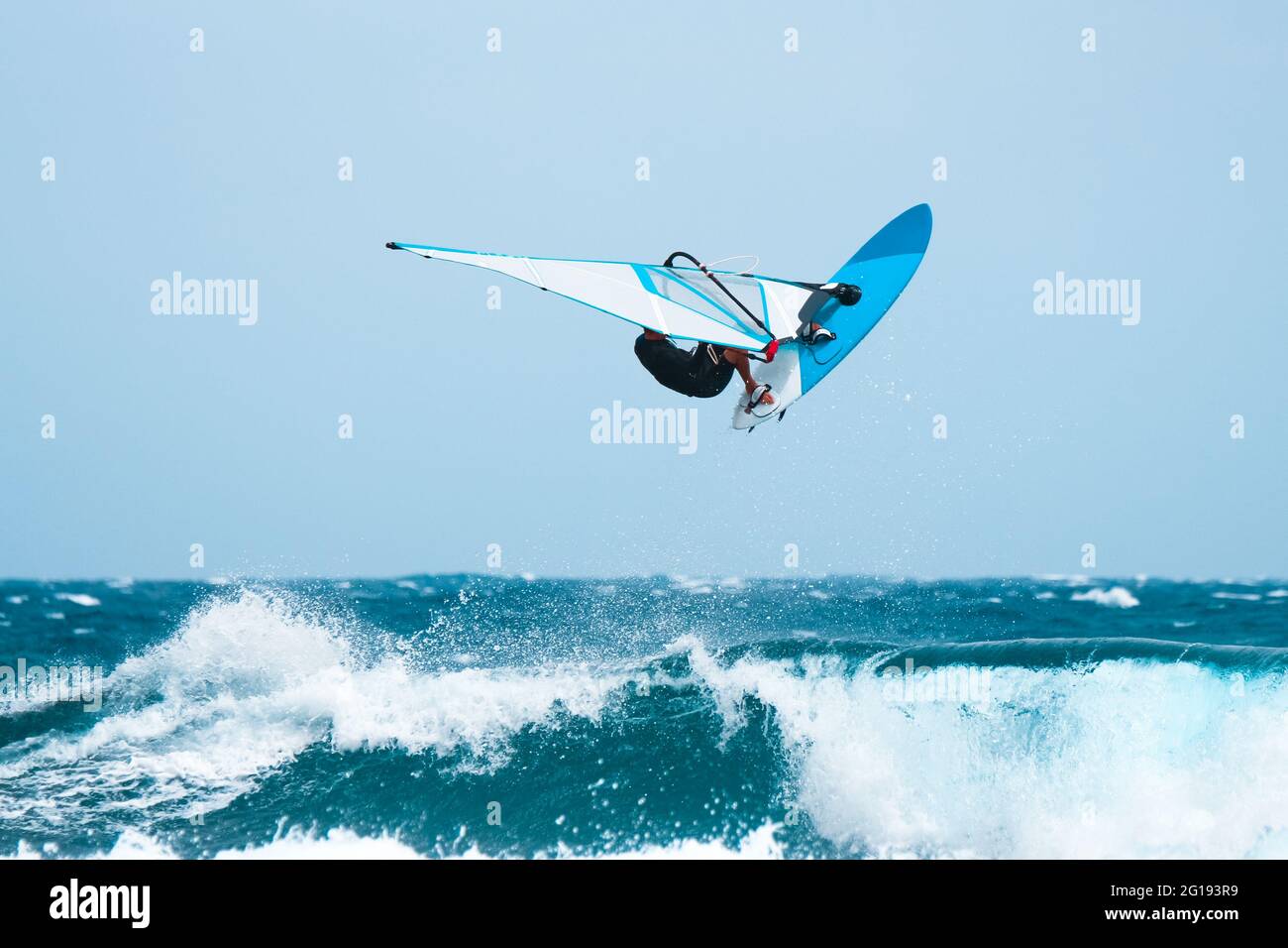 aquatic sports: windsurfer jumping on the waves during the summer Stock Photo