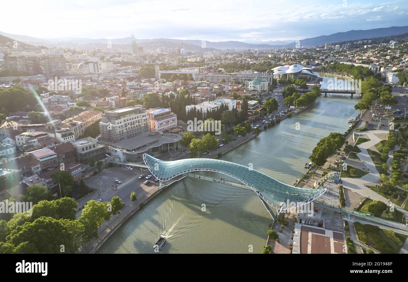 Freedom bridge on Tbilisi landscape background aerial drone view Stock Photo
