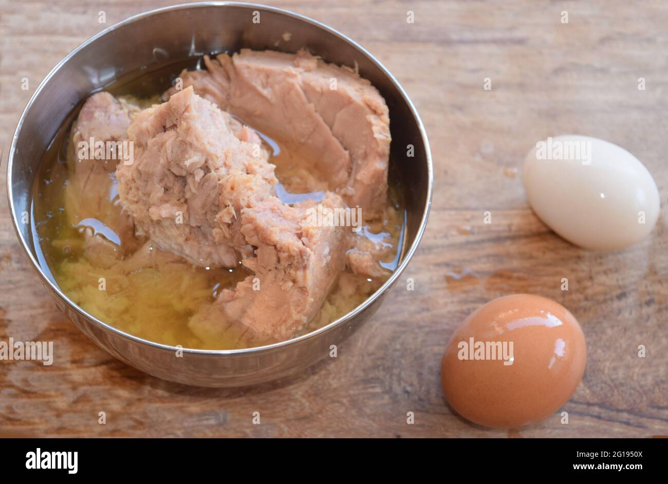 preparation of tuna in oil and hardboiled eggs in salad Stock Photo