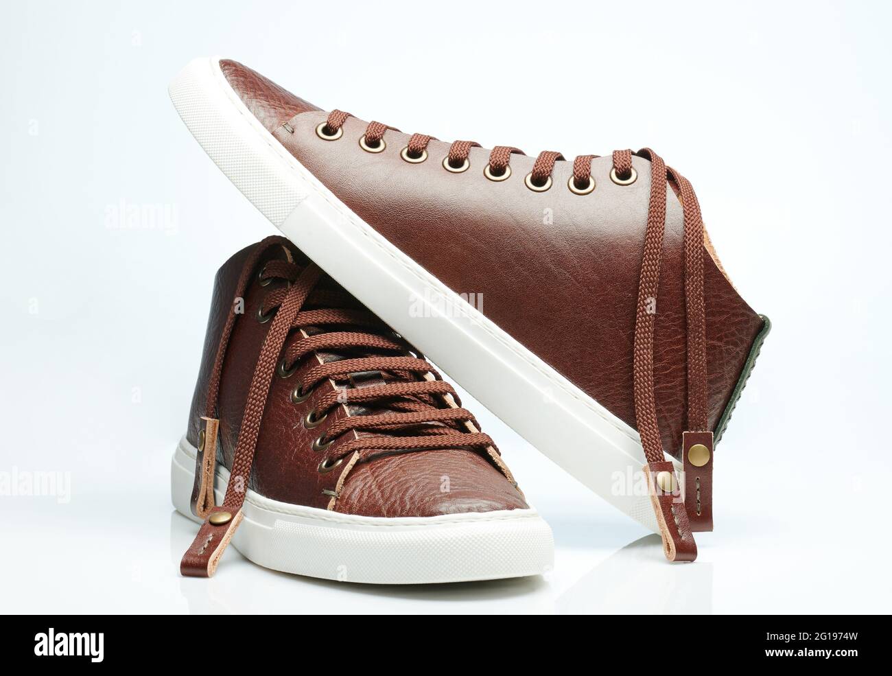 Pair of brown leather sneakers with white sole isolated Stock Photo