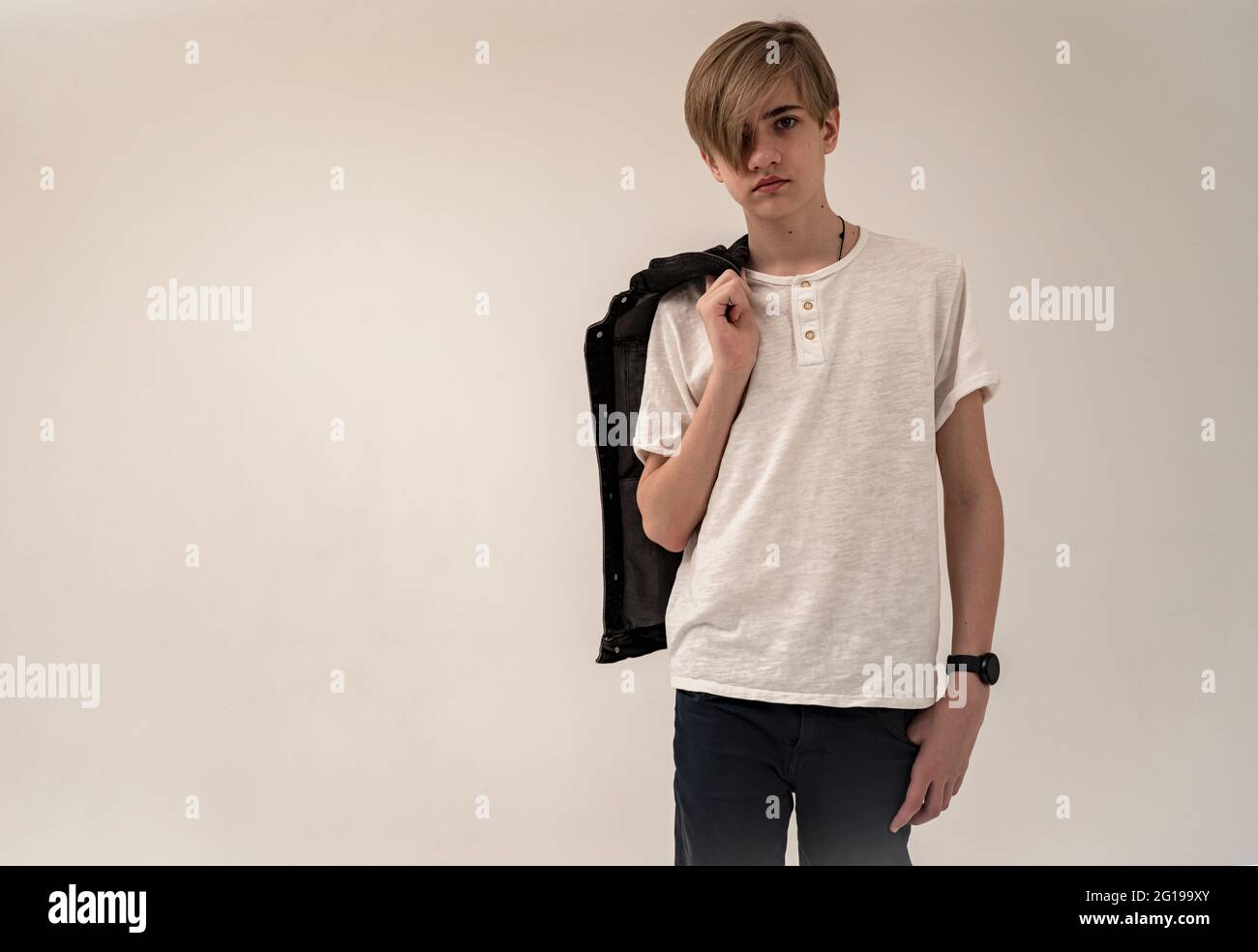 High school student teenager with a sad expression on his face. Cute pretty  teenager boy in casual clothes. Stock Photo