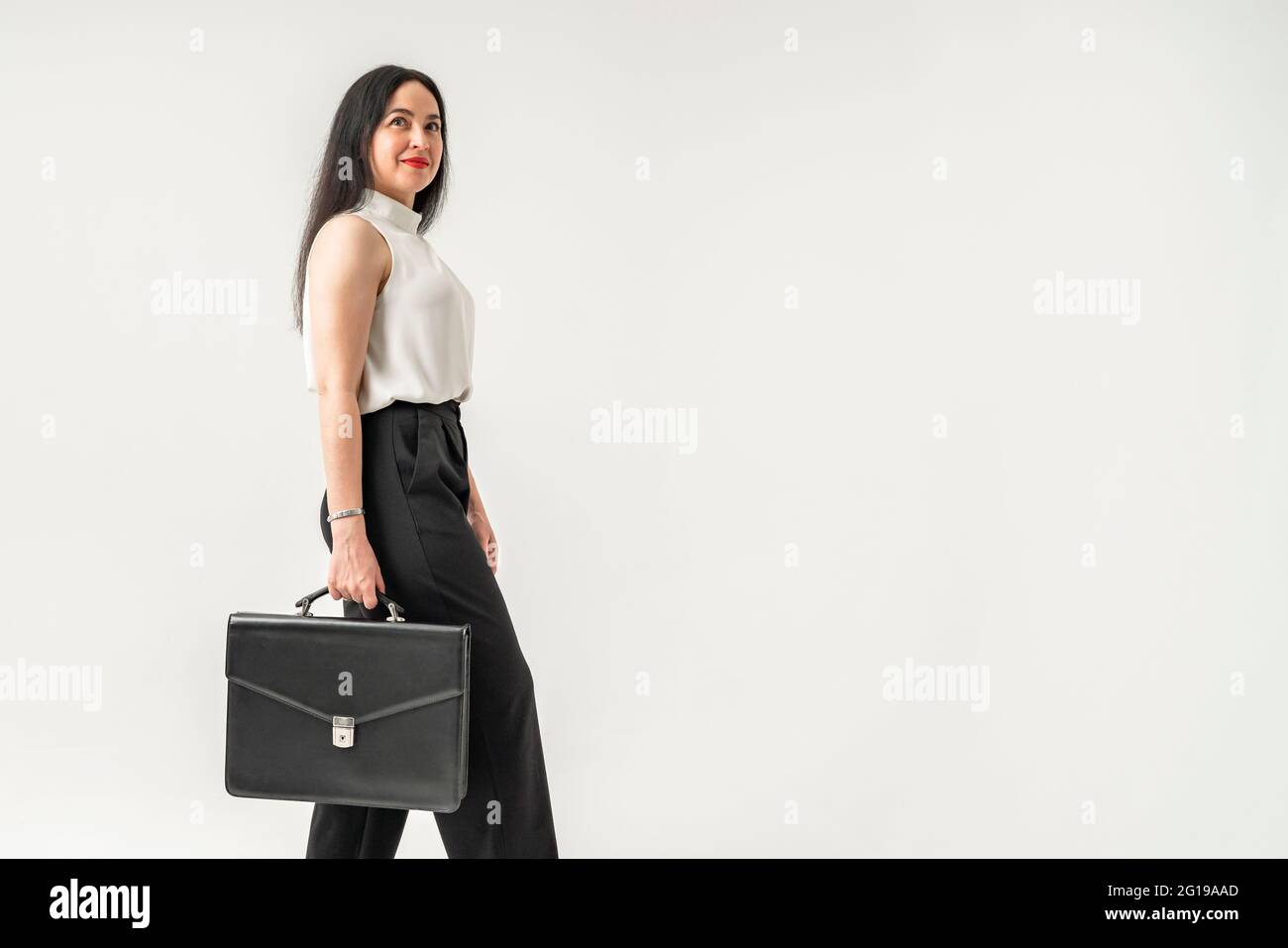 Portrait of confident young businesswoman stand forefront looking at camera, successful millennial female ceo or boss posing for picture in office. Stock Photo