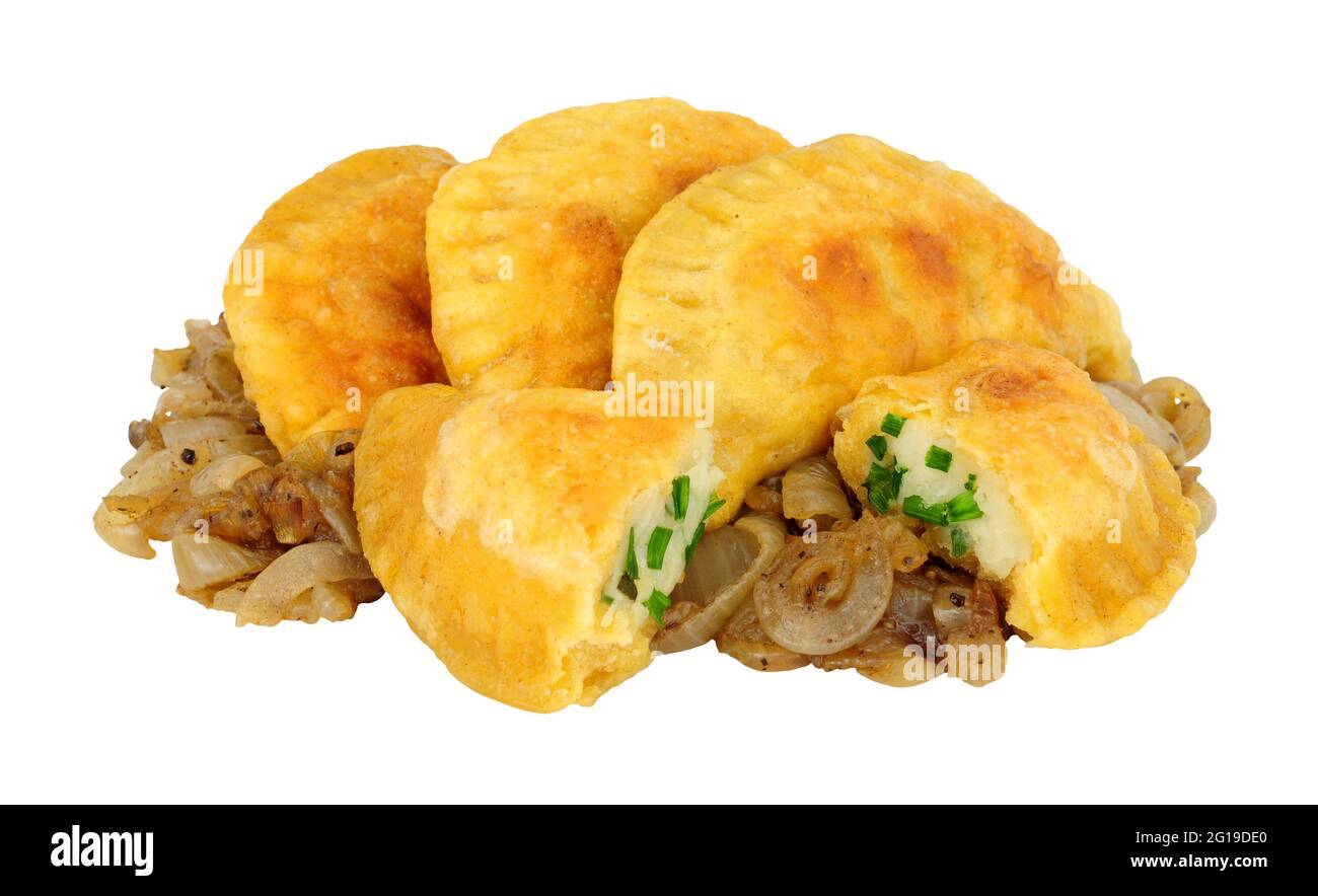 Group of potato and cheese filled Pierogi dumplings with fried onions isolated on a white background Stock Photo