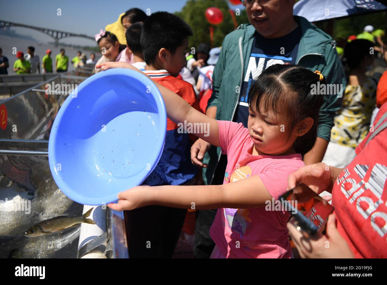 Changsha, China's Hunan Province. 6th June, 2021. People release fish fry at Juzizhou Park in Changsha, central China's Hunan Province, June 6, 2021. About 80.32 million fish fry were released into the Xiangjiang River in Changsha on Sunday. June 6 has been observed in China as the national fish releasing day to help promote ecological awareness. Credit: Xue Yuge/Xinhua/Alamy Live News Stock Photo
