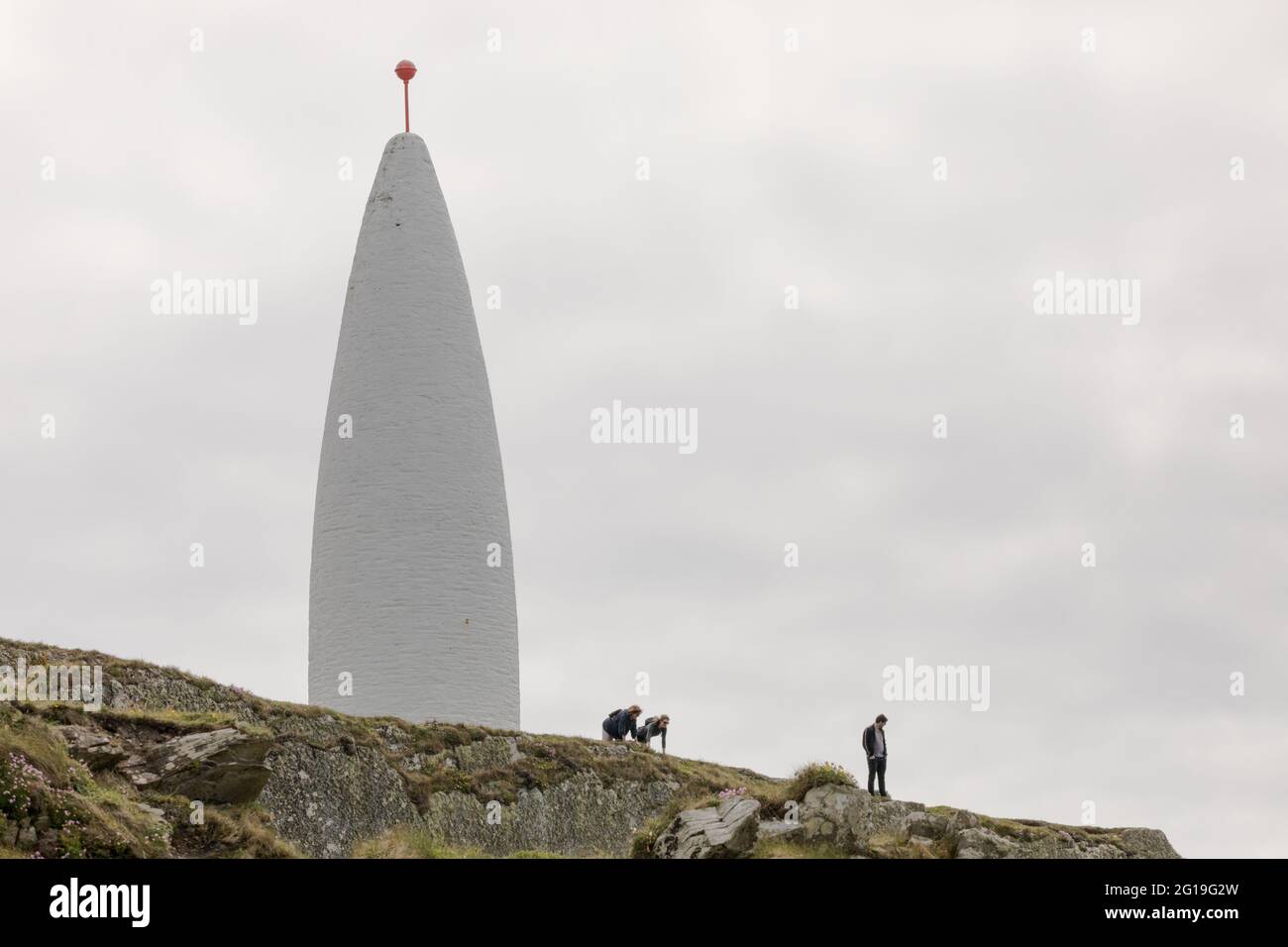 Baltimore, Cork, Ireland. 05th June, 2021. Two visitors get down on their hands and kness to check the drop down to the sea from the cliffs at the Beacon in Baltimore, Co. Cork, Ireland.   - Credit; David Creedon / Alamy Stock Photo