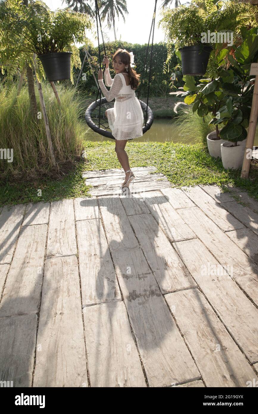 Woman swinging rope hi-res stock photography and images - Alamy