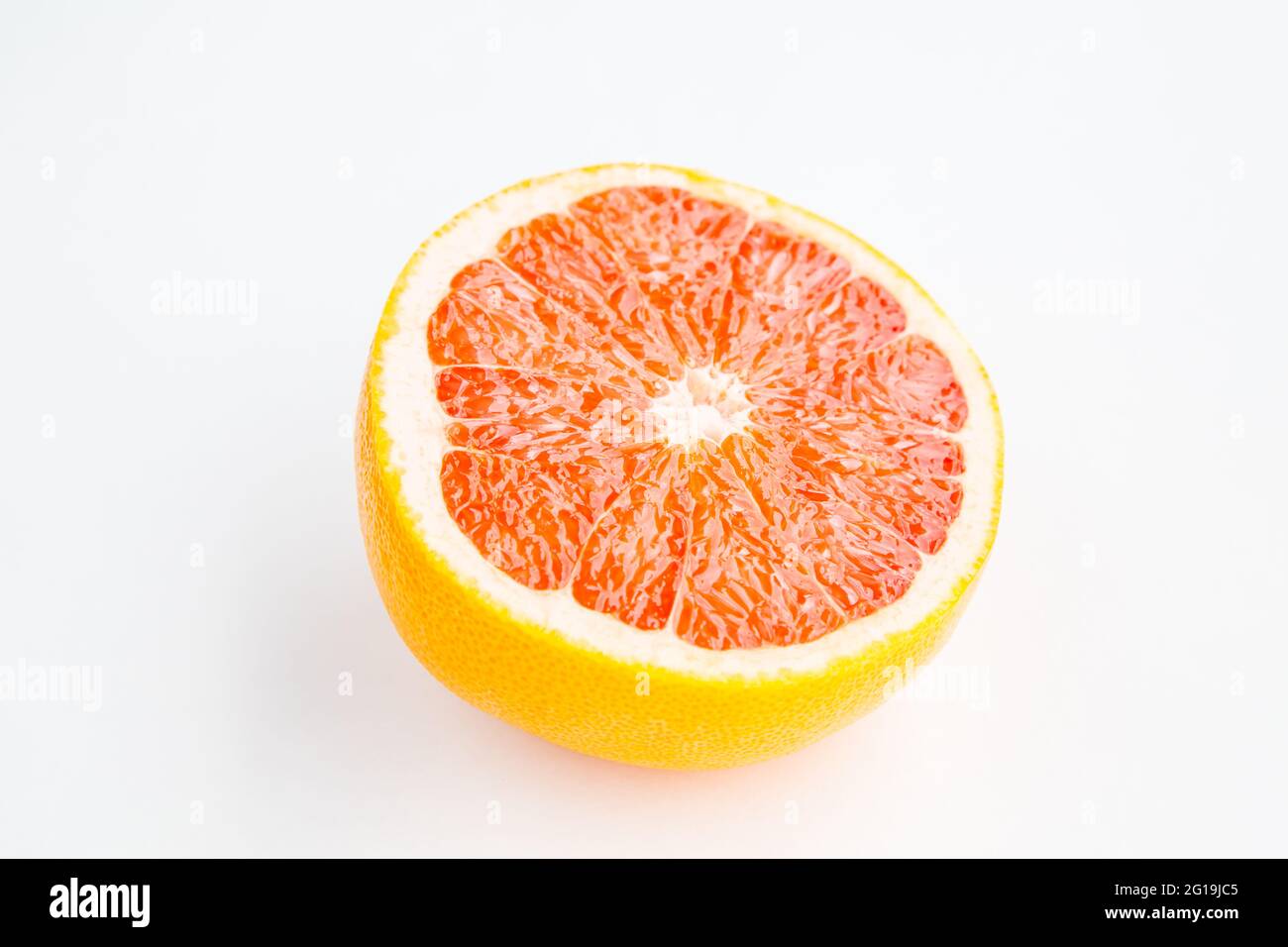Fresh red grapefruit half cut isolated on white background Stock Photo