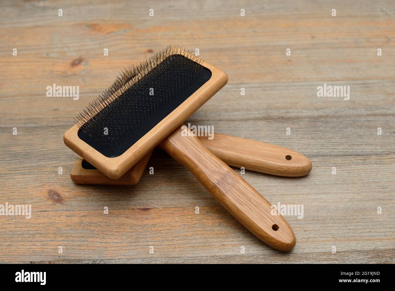two carding brushes for combing wool on wooden background Stock Photo