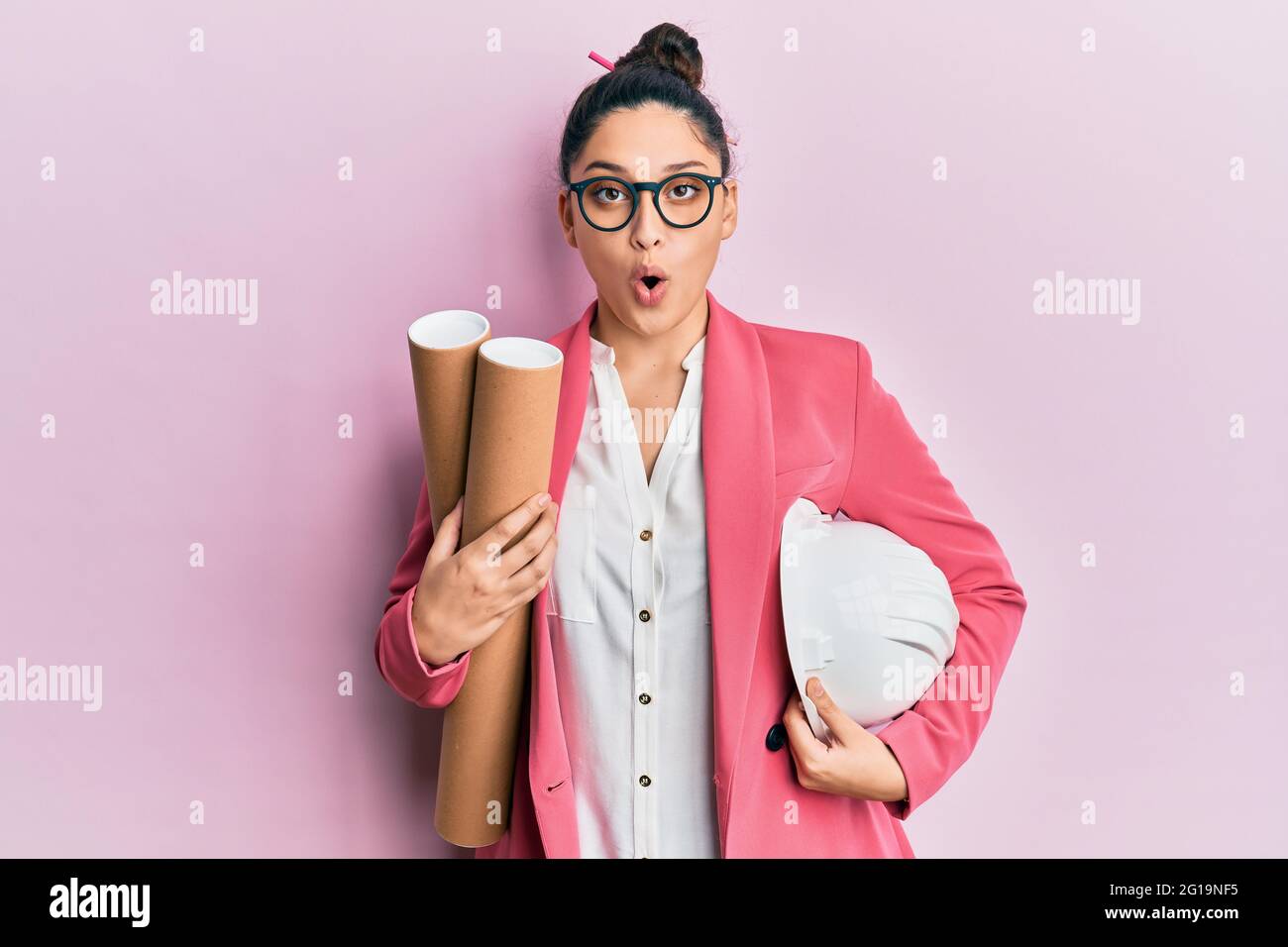 Afraid Paper Beautiful middle eastern woman holding paper blueprints afraid and ...