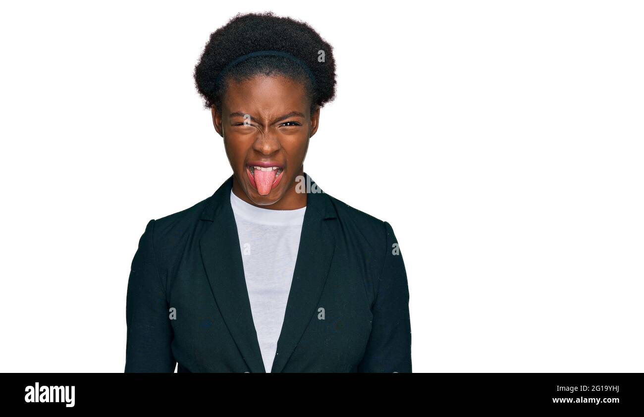 Young african american girl wearing business clothes sticking tongue ...