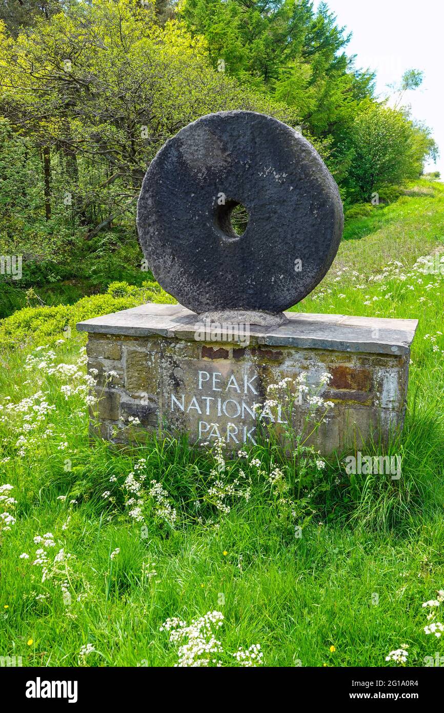 A millstone marking the Peak District National Park boundary on the edge of Sheffield, South Yorkshire, North of England, UK Stock Photo