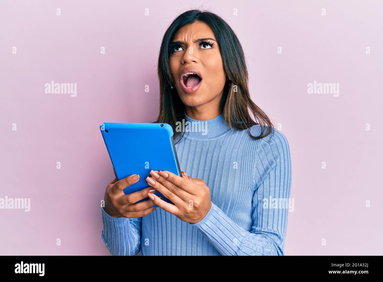Young Latin Transsexual Transgender Woman Using Touchpad Device Angry And Mad Screaming