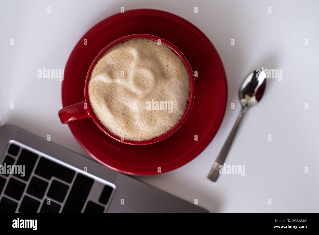 Flat Lay office desk. Red cup with coffee top view.Work from home. desk office with laptop and coffee cup on a white table. Flat lay top view copy Stock Photo