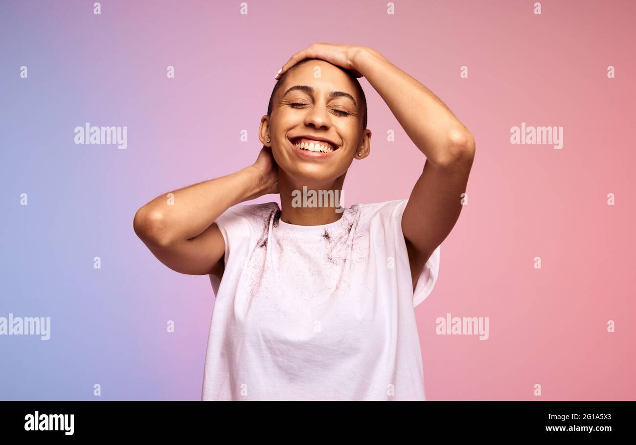 Happy woman with bald shaved hair. Female with short hair on colorful background. Stock Photo