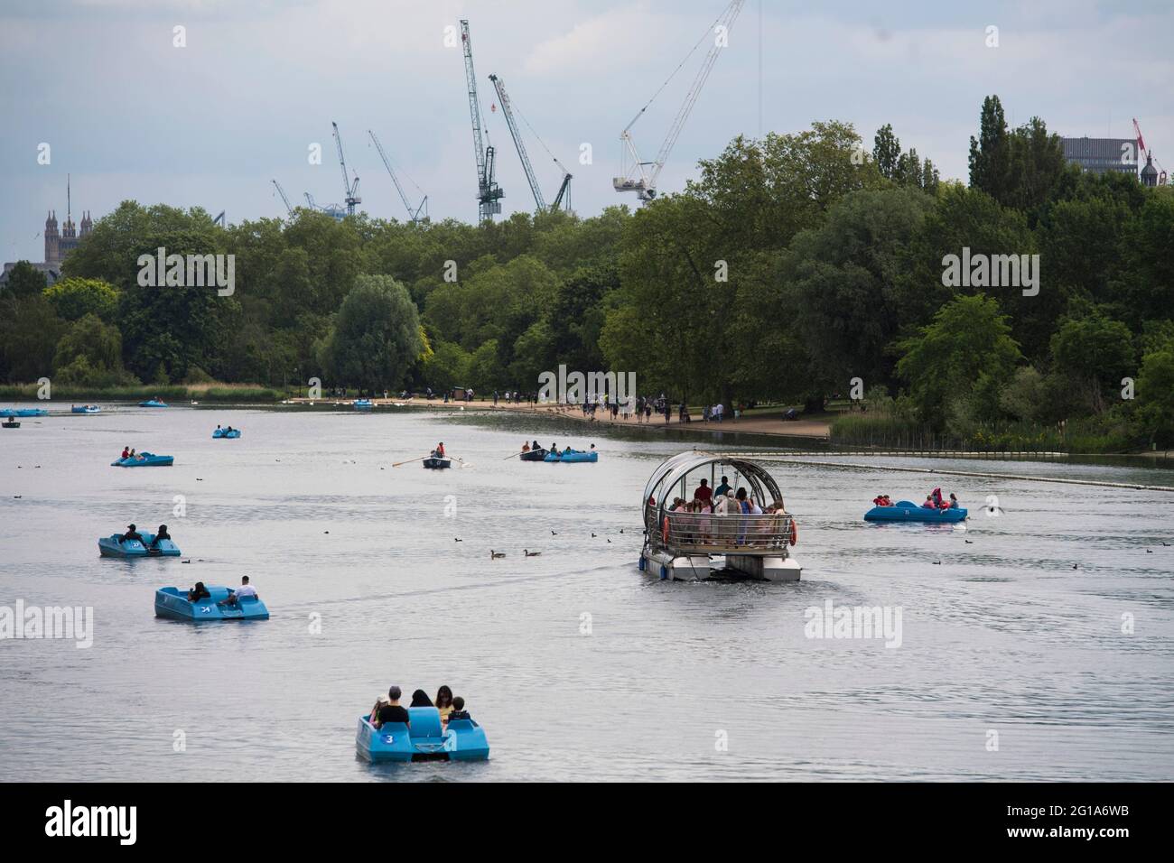 People in pedalos on the Serpentine, Hyde Park, London. Picture date