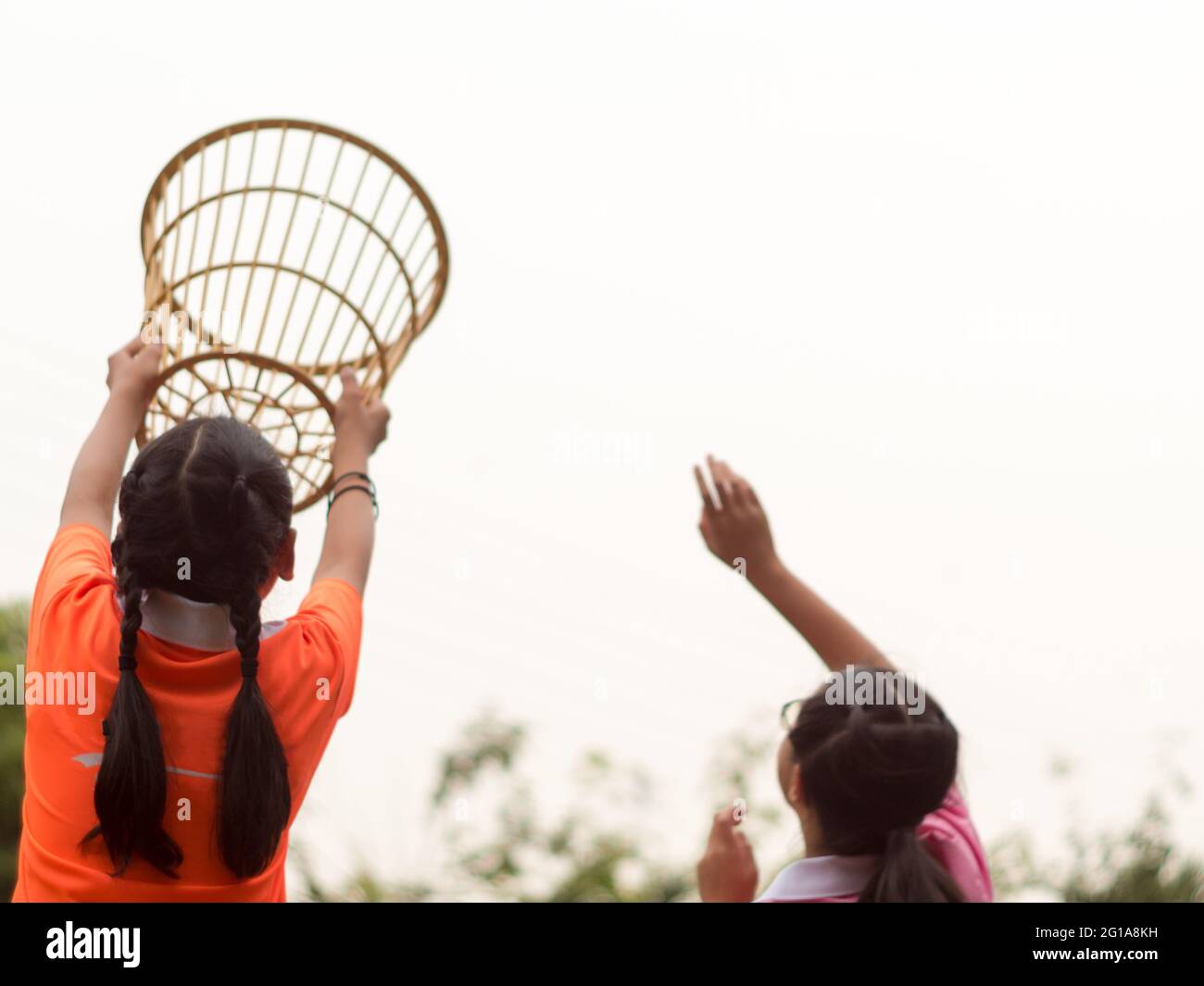 A girl in a basket holding position in a school chairball game Stock Photo Alamy