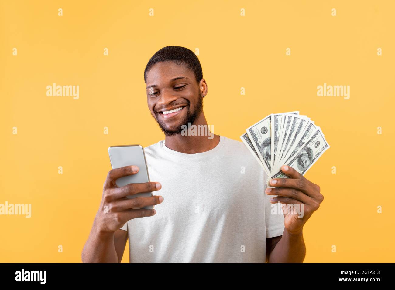 Make money online and cashback concept. Happy black guy using ...
