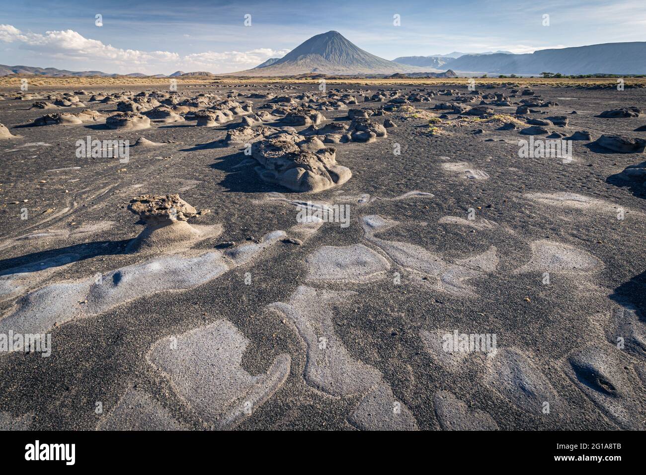 Mudflats close to Lake Natron with Ol Doinyo Lengai volcano in the background; Tanzania Stock Photo