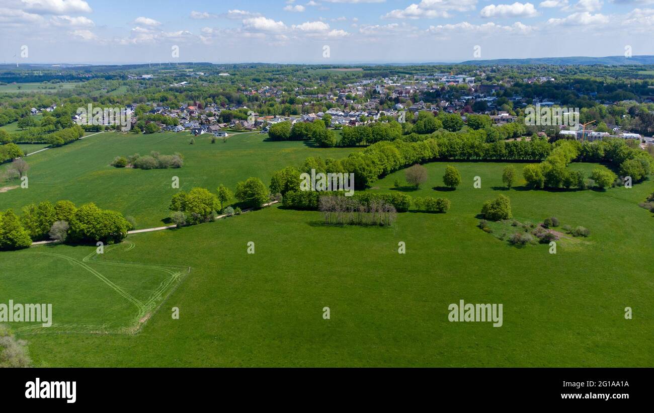 Aerial view of landscape in the Eifel region with the city Simmerath, forest and farmland Stock Photo