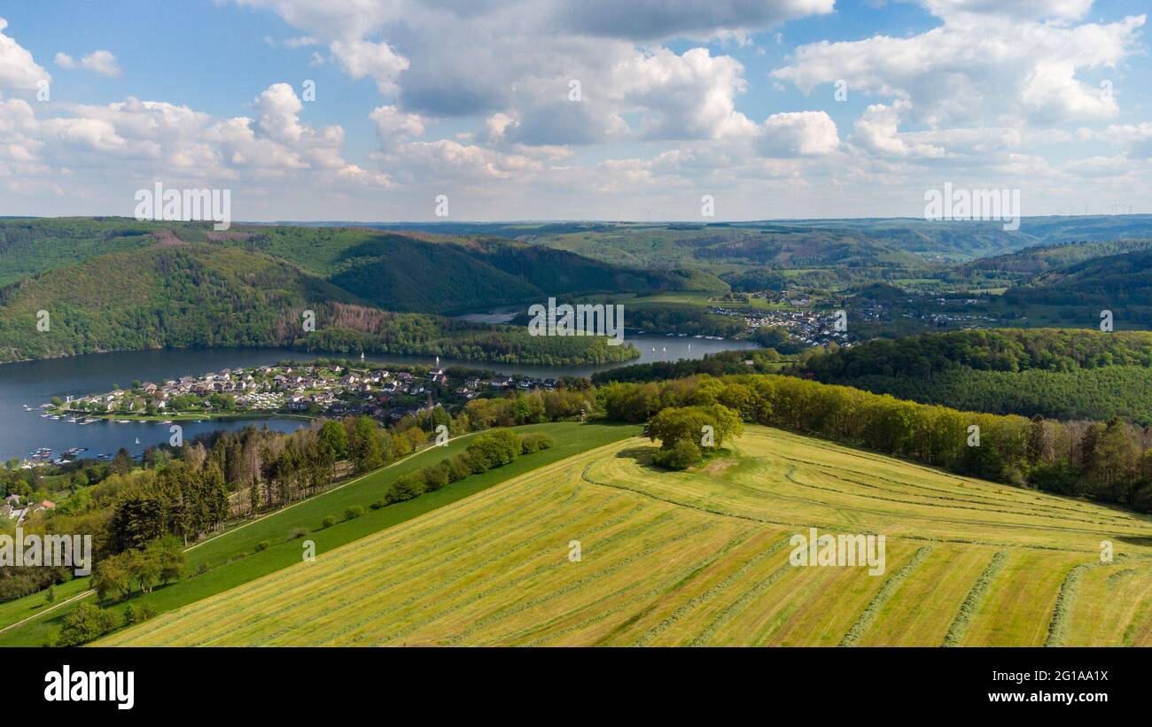 Aerial view of the Rursee in the Eifel region, Germany with farmland in the foreground and district Woffelsbach Stock Photo