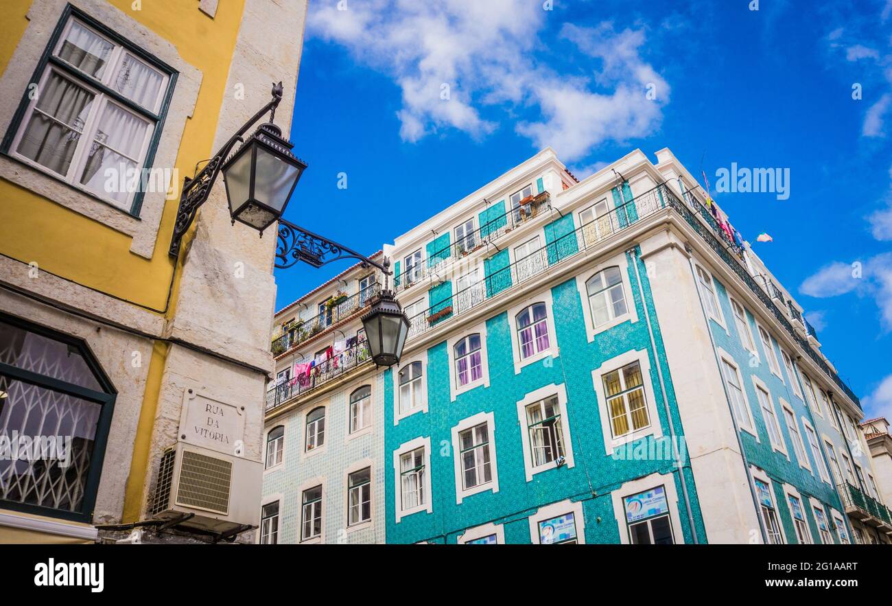 LISBON, PORTUGAL - MARCH 25, 2017: Colorful blue and yellow buildings of Lisbon, Portugal. Vintage lantern on buildings facade. Rua Da Vitoria street Stock Photo