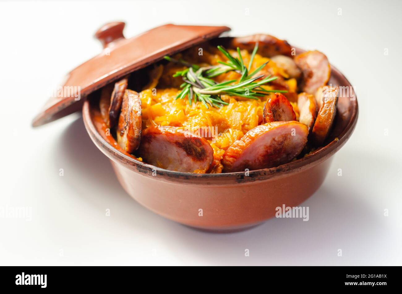 Traditional Polish dish called bigos made of sauerkraut, sausage and mushrooms, food served warm in a ceramic bowl, Eastern European food Stock Photo