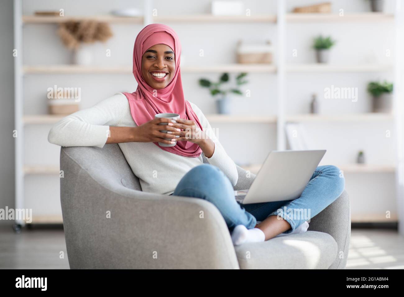 Domestic Leisure. Black Muslim Lady Relaxing At Home With Laptop And ...