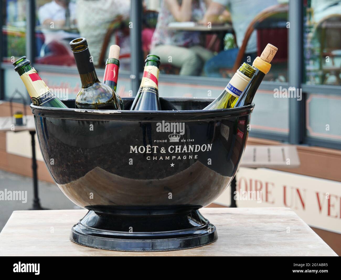 Several open bottles of luxury champagne, including MOET and CHANDON in one of the restaurant in France Stock Photo