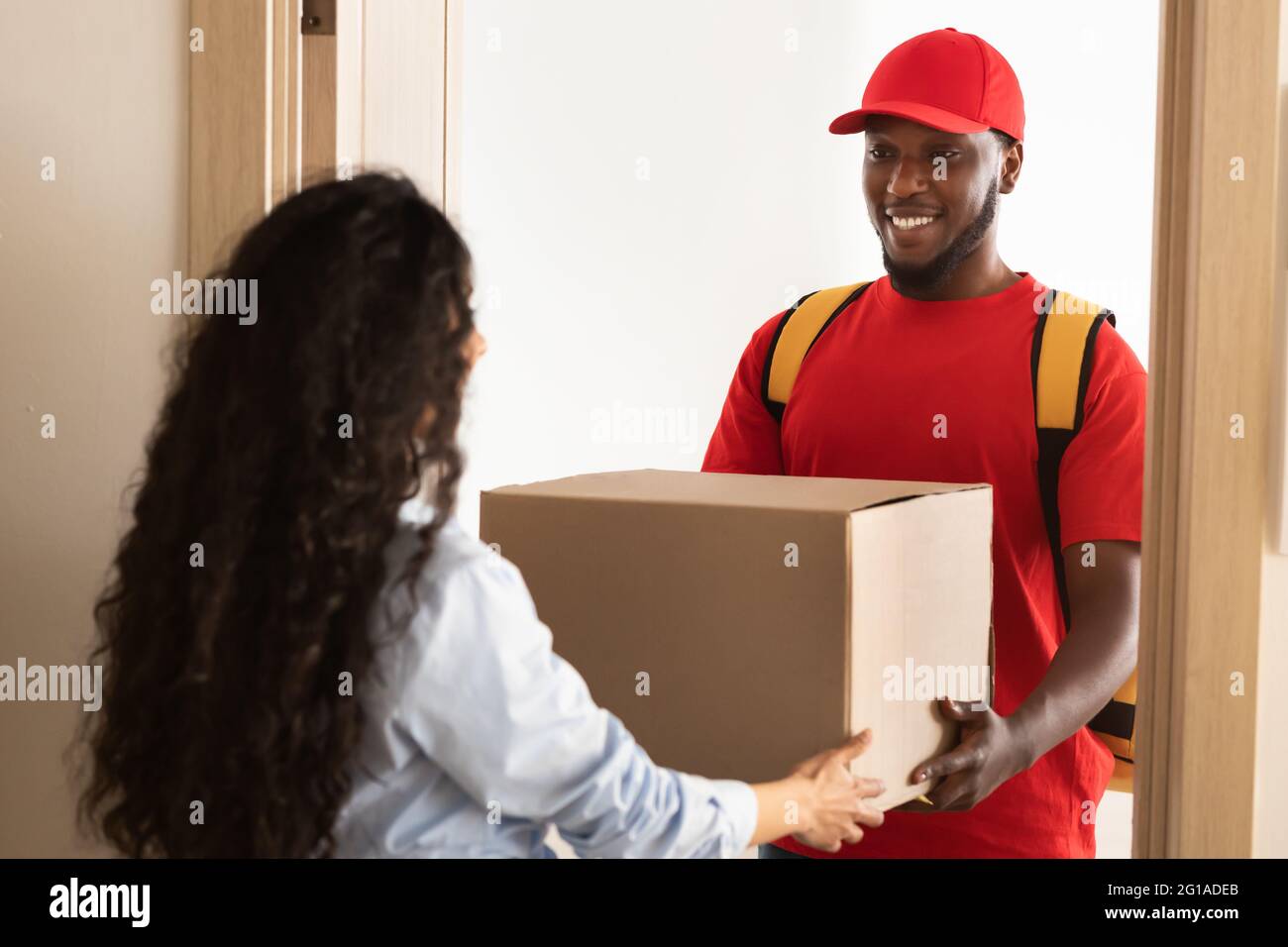 Delivery Man Holding Cardboard Boxes In Rubber Gloves Isolated