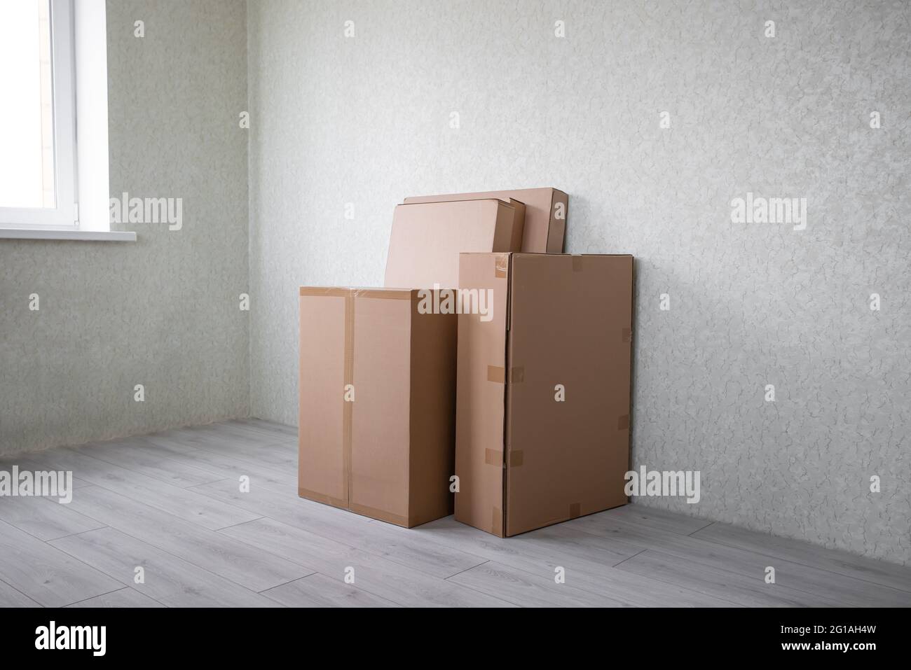 Brand  new selection of furniture in cardboard boxes just arrived in new home Stock Photo