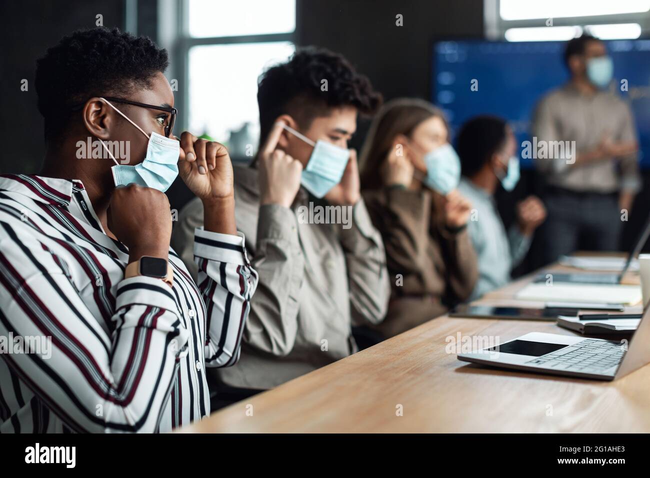 International business people wearing medical masks using laptops Stock ...