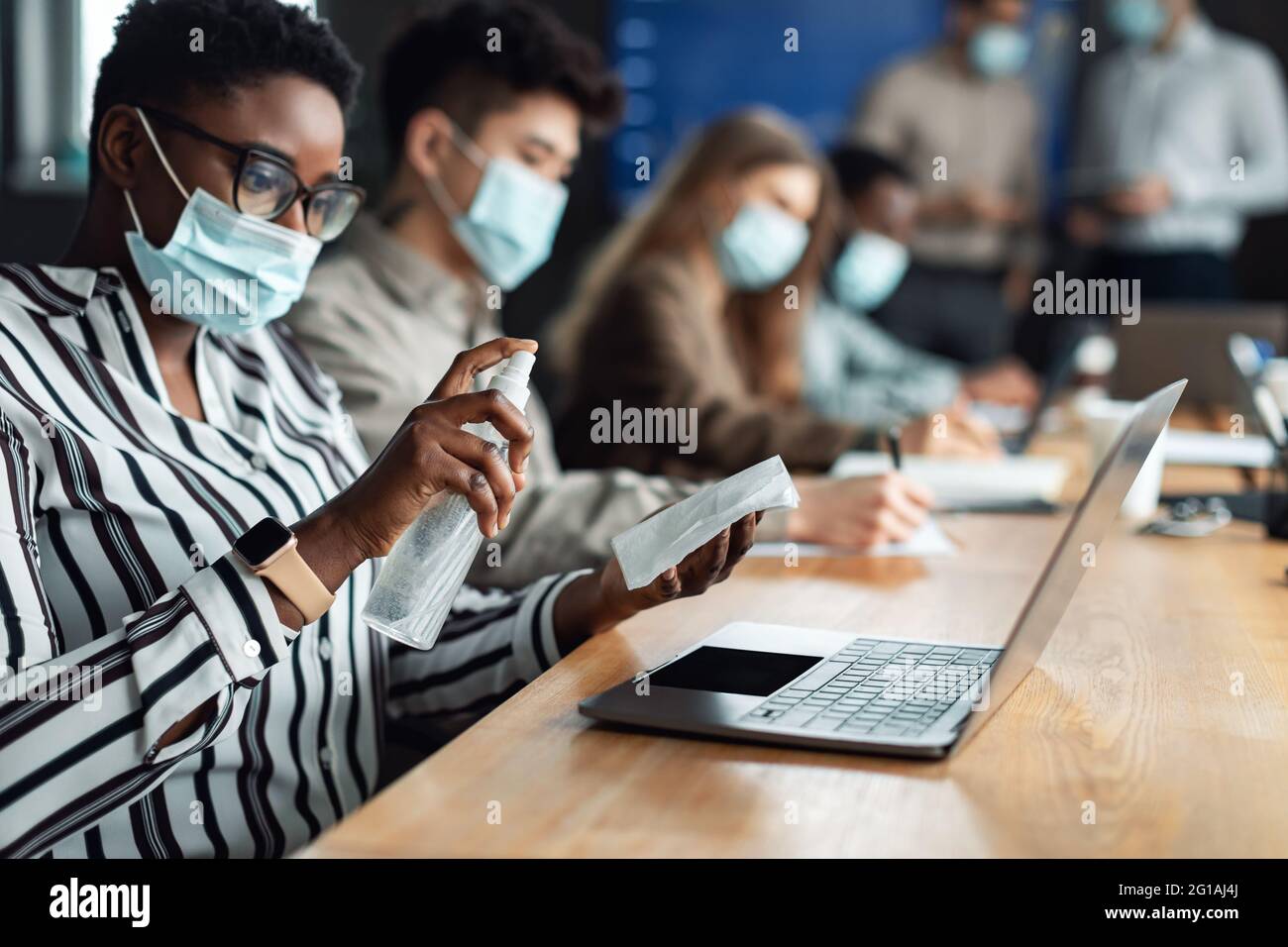 Black woman wearing medical masks using sanitizer Stock Photo - Alamy
