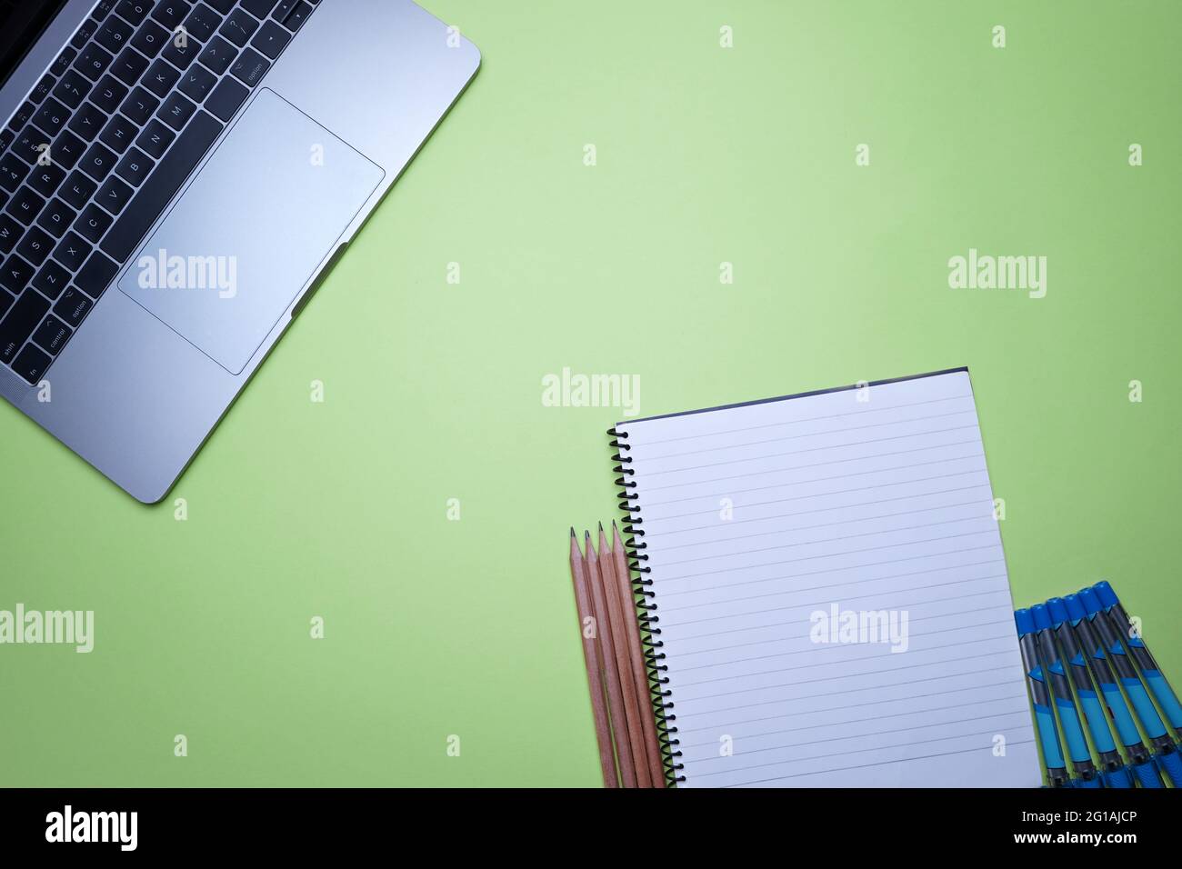 Table top flat lay of office. Top view laptop, Spiral notebook and
