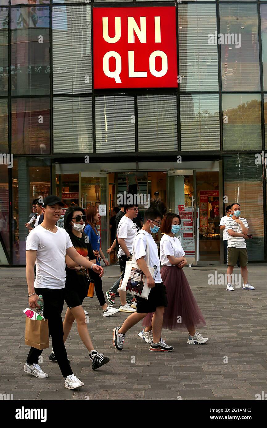 Beijing, China. 06th June, 2021. Chinese shoppers walk past a Fast  Retailing's clothing chain UNIQLO in Beijing on Sunday, June 6, 2021. UNIQLO  has come under harsh criticism and clothing boycotts due
