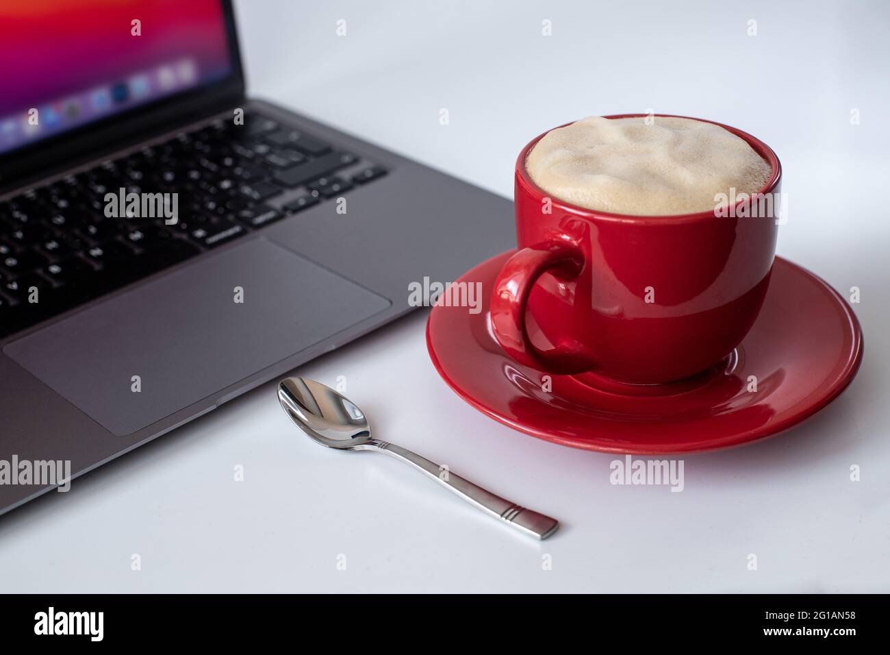 A cup of coffee and a laptop computer are on the table. Selective focus Stock Photo