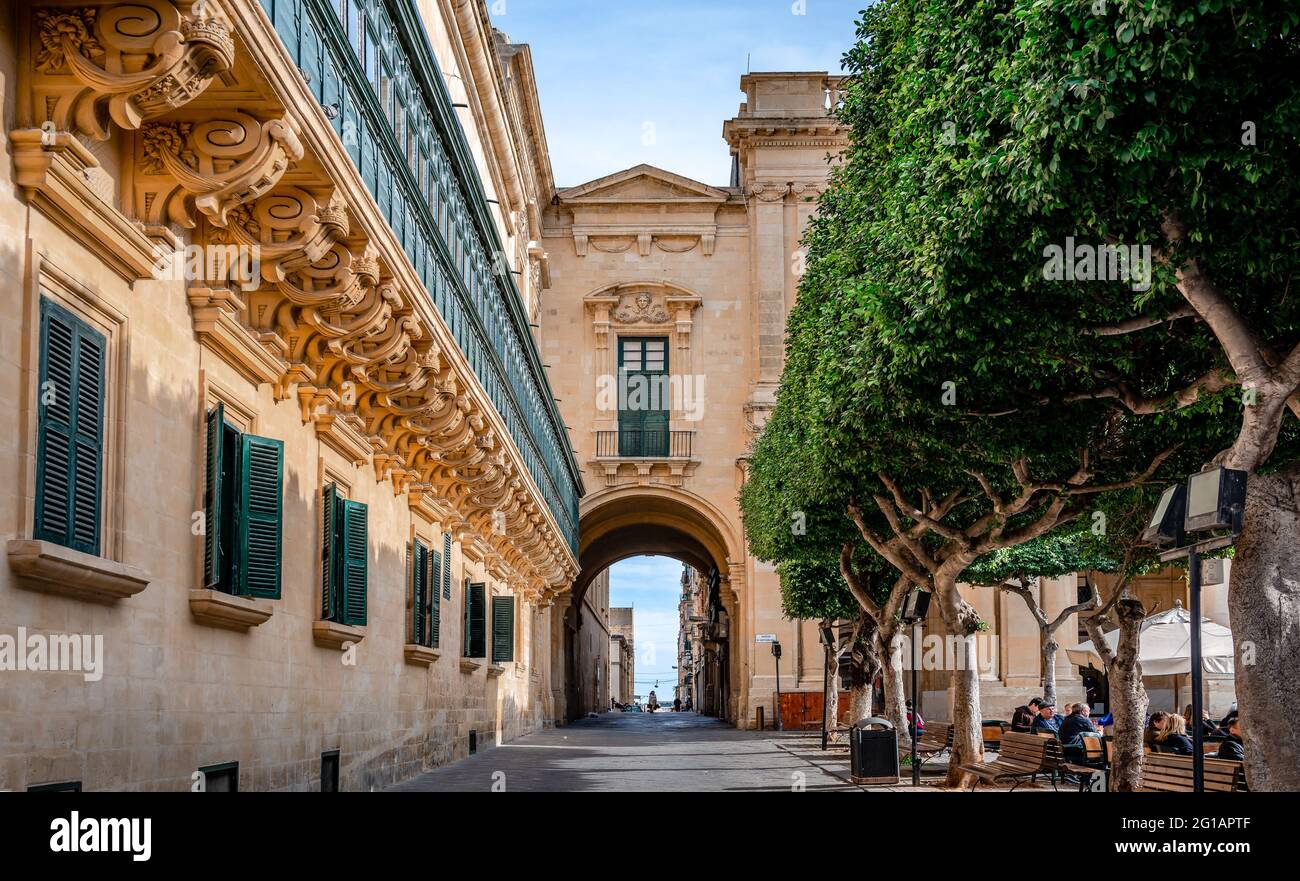 Valletta, Malta - February 20 2015: Panoramic view of the Old Theatre Street, on a sunny winter afternoon. The Republic square is on the right. Stock Photo