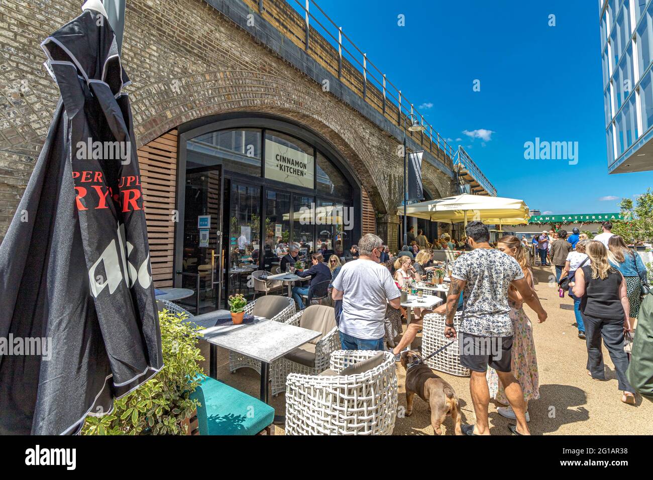 People eating outside at The Cinnamon Kitchen, an Indian restaurant at